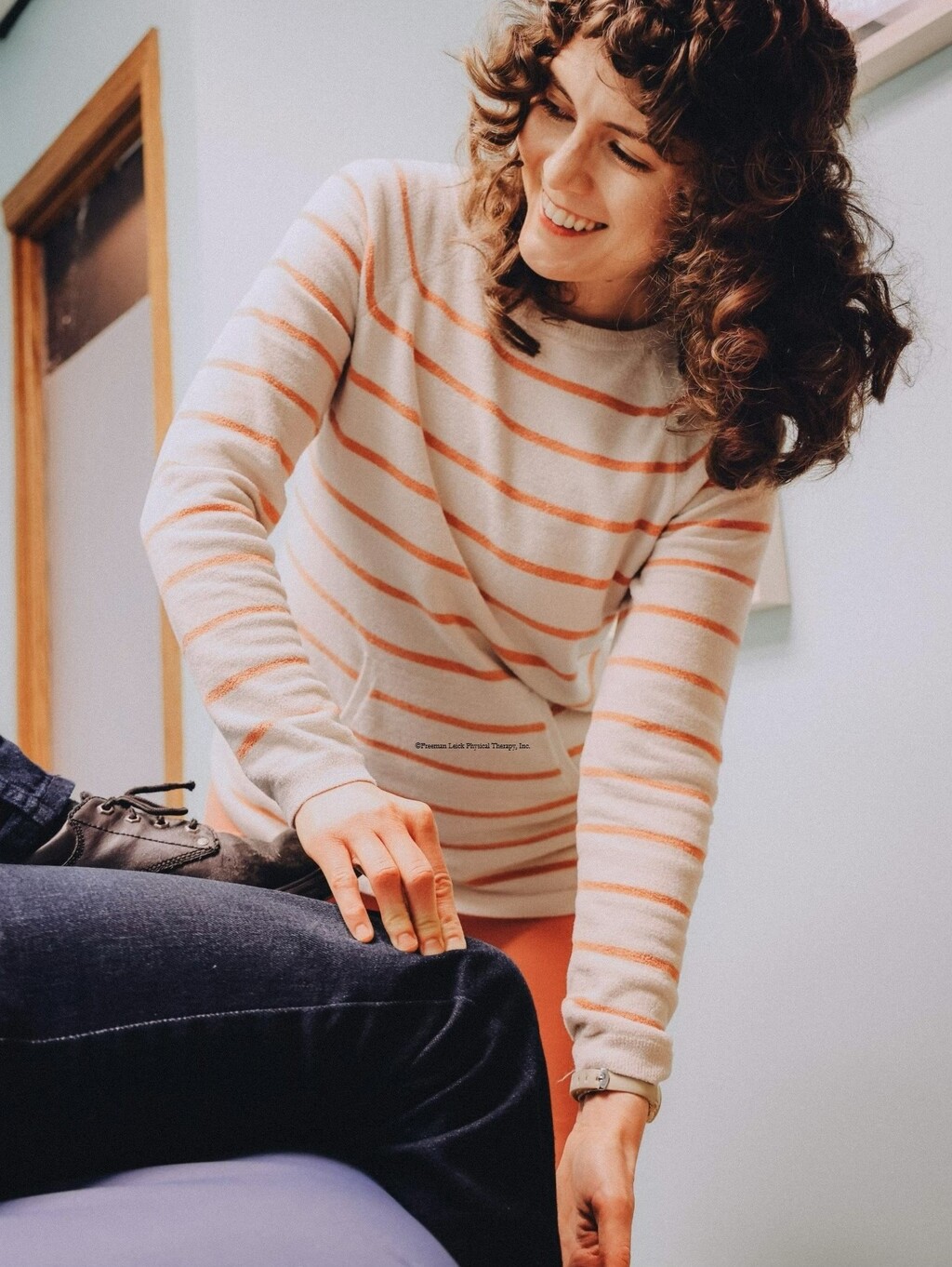 Melissa testing someone's knee and leg movements